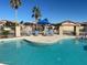 Community pool with lounge chairs, umbrellas, and desert landscaping at 1306 N Lantana N Pl, Casa Grande, AZ 85122