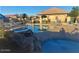 Community pool and hot tub with lounge chairs and shaded areas at 1306 N Lantana N Pl, Casa Grande, AZ 85122