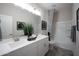 This bathroom features a double sink vanity, a large mirror, and a shower/tub with neutral tiling at 13195 N 145Th Ln, Surprise, AZ 85379