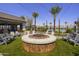 Inviting community fire pit area has Adirondack chairs, artificial turf, and bistro lights to create a place to gather at 13195 N 145Th Ln, Surprise, AZ 85379