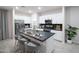 Modern kitchen featuring white cabinetry, a central island with seating, and stainless steel appliances at 13195 N 145Th Ln, Surprise, AZ 85379