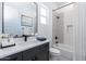 Stylish bathroom featuring modern vanity, large mirror, bathtub with tiled walls, and a bright window at 13914 E Barwick Dr, Scottsdale, AZ 85262