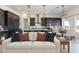 Elegant kitchen and dining area featuring dark cabinets, modern lighting, and an open layout at 13914 E Barwick Dr, Scottsdale, AZ 85262