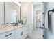 A modern bathroom featuring white cabinets, a quartz countertop, matte black hardware, and tile flooring at 13929 E Barwick Dr, Scottsdale, AZ 85262