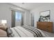 Bright bedroom with modern decor featuring a large window and wood dresser, blending style with comfort at 13929 E Barwick Dr, Scottsdale, AZ 85262