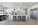 Bright modern kitchen with white cabinets, stainless steel appliances, and a large center island with barstool seating at 13929 E Barwick Dr, Scottsdale, AZ 85262