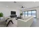 Modern living room with contemporary furniture, large windows, and sleek entertainment center at 13929 E Barwick Dr, Scottsdale, AZ 85262