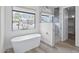 Bright bathroom featuring a modern tub, a glass shower, and a large window view at 14328 E Peak View Rd, Scottsdale, AZ 85262