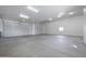 Spacious three-car garage with ample lighting and concrete flooring at 14328 E Peak View Rd, Scottsdale, AZ 85262