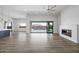 Bright living room featuring a fireplace, ceiling fan and floor-to-ceiling sliding glass doors at 14328 E Peak View Rd, Scottsdale, AZ 85262