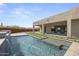 Beautiful pool with waterfall feature, artificial turf and travertine pavers at 14328 E Peak View Rd, Scottsdale, AZ 85262