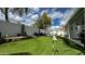 Backyard putting green with inviting lounge areas, a stone retaining wall, and privacy fencing at 1450 N Sailors Way, Gilbert, AZ 85234