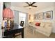 Cozy bedroom featuring a comfortable sofa, desk, and large window providing natural light at 1450 N Sailors Way, Gilbert, AZ 85234