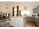 Contemporary kitchen island with wooden countertop and grey cabinets, perfect for gatherings and culinary creations at 1450 N Sailors Way, Gilbert, AZ 85234