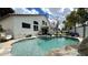 Inviting backyard pool with water feature, lounge chairs, and outdoor seating under a covered patio at 1450 N Sailors Way, Gilbert, AZ 85234