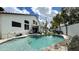 Sparkling pool with rock waterfall feature, surrounded by lounge chairs and an open-air patio at 1450 N Sailors Way, Gilbert, AZ 85234