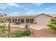 Inviting back patio area with covered seating and meticulous desert landscaping, perfect for outdoor relaxation and entertaining at 15816 W Amelia Dr, Goodyear, AZ 85395