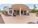 Expansive backyard with a covered patio, outdoor grill, and manicured landscaping at 15816 W Amelia Dr, Goodyear, AZ 85395