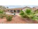 Tranquil backyard featuring a covered patio and vibrant desert landscaping at 15816 W Amelia Dr, Goodyear, AZ 85395