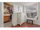 Bedroom showcases a walk-in closet, window bench, white chest of drawers, and light wood flooring at 15816 W Amelia Dr, Goodyear, AZ 85395