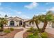 Charming home featuring desert landscaping with palm trees and a welcoming walkway leading to the front door at 15816 W Amelia Dr, Goodyear, AZ 85395