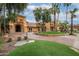 Stately home featuring a grand entrance, lush landscaping, and mature palm trees for added curb appeal at 15816 W Amelia Dr, Goodyear, AZ 85395