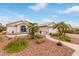 Well-maintained single-story home featuring desert landscaping, palm trees, and a welcoming walkway at 15816 W Amelia Dr, Goodyear, AZ 85395