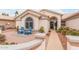 Charming front patio with mature desert landscaping and two blue Adirondack chairs at 15816 W Amelia Dr, Goodyear, AZ 85395