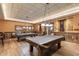 Spacious game room featuring pool tables, seating, and warm lighting for social gatherings at 15816 W Amelia Dr, Goodyear, AZ 85395