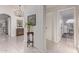 Hallway with tile floors and neutral wall paint, a vintage table, and lots of natural light at 15816 W Amelia Dr, Goodyear, AZ 85395