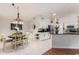 Bright kitchen with stainless steel appliances, white cabinets, and adjacent dining area at 15816 W Amelia Dr, Goodyear, AZ 85395