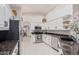 Modern kitchen with stainless steel appliances, white cabinetry, and ample counter space at 15816 W Amelia Dr, Goodyear, AZ 85395