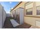 This backyard shows two storage sheds installed near a wall and a window at 16026 W Cortez St, Surprise, AZ 85379