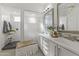 Bright bathroom with a double sink vanity, decorative mirrors, and a glass-enclosed shower at 16026 W Cortez St, Surprise, AZ 85379