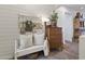 Charming hallway nook featuring a decorative bench, vintage dresser, and shiplap wall accents at 16026 W Cortez St, Surprise, AZ 85379