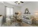 Cozy living room featuring comfortable seating, a shiplap accent wall, and natural light at 16026 W Cortez St, Surprise, AZ 85379