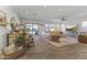 Bright living room with wood floors, white ship lap accent wall, and access to the outdoor patio at 16026 W Cortez St, Surprise, AZ 85379