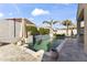 Backyard pool area featuring landscaping, tile patio, BBQ, and palm trees at 16026 W Cortez St, Surprise, AZ 85379