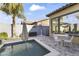 Backyard pool area with a patio table, umbrella, landscaping, and BBQ at 16026 W Cortez St, Surprise, AZ 85379