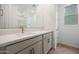 Bright bathroom featuring a large vanity, undermount sink, and sleek fixtures, complemented by neutral-toned flooring and a window at 17307 W Via Dona Rd, Surprise, AZ 85387