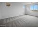 This bedroom features neutral walls, carpet, and natural light at 17307 W Via Dona Rd, Surprise, AZ 85387