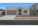 Contemporary single-story home featuring a two-car garage, modern design, and drought-tolerant landscaping at 17307 W Via Dona Rd, Surprise, AZ 85387