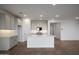 Bright, open kitchen with white cabinets, a large island, stainless steel appliances and hard wood floors at 17307 W Via Dona Rd, Surprise, AZ 85387