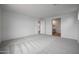 Spacious bedroom with neutral walls, carpeted floor and ensuite bathroom at 17307 W Via Dona Rd, Surprise, AZ 85387