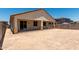 View of the back of the home with covered patio at 17547 W Lupine Ave, Goodyear, AZ 85338