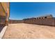 A large, fenced-in backyard with dirt and block wall at 17547 W Lupine Ave, Goodyear, AZ 85338