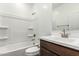 Bright bathroom features a white vanity and shower-tub combo at 17547 W Lupine Ave, Goodyear, AZ 85338