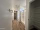 Hallway access to a bathroom featuring a glass shower enclosure and a view of a walk-in closet at 17547 W Lupine Ave, Goodyear, AZ 85338