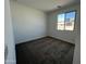 Neutral bedroom with carpet flooring and a view to the outside at 17547 W Lupine Ave, Goodyear, AZ 85338