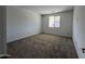 Comfortable bedroom with carpet flooring and a window at 17547 W Lupine Ave, Goodyear, AZ 85338